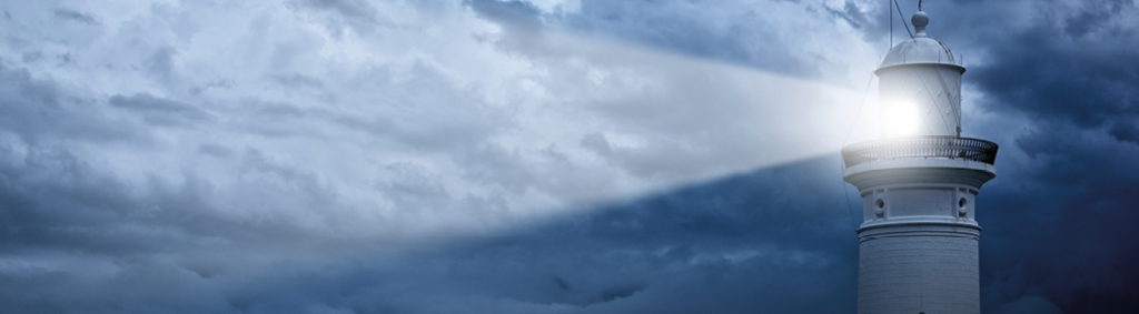 about us lighthouse searchlight in clouds